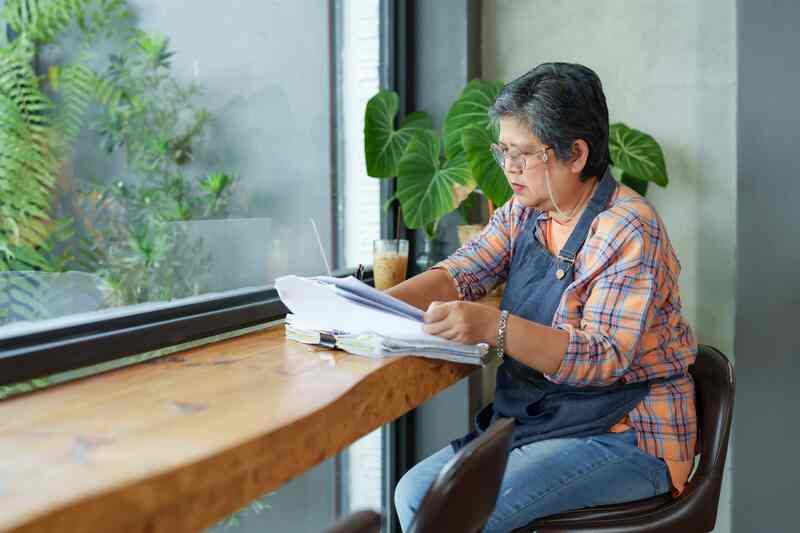Asian senior woman with accounting documents