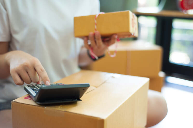 Small Business owner with boxes and calculator