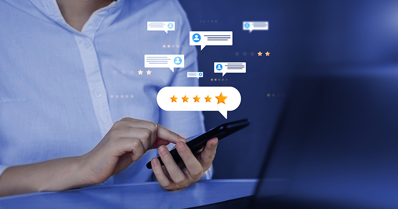 A man holding a smartphone with a 5-star review displayed above it.