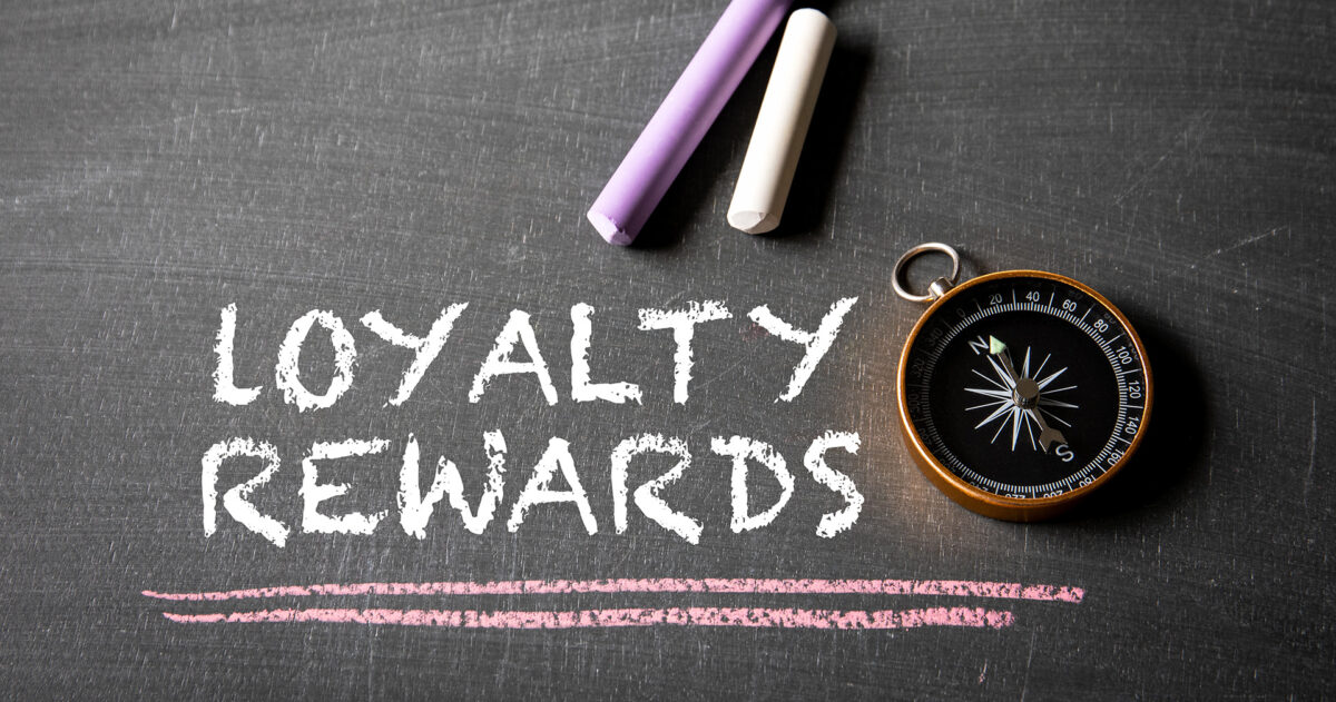 The-words-_loyalty-rewards_-written-in-chalk-with-a-compass-next-to-them.