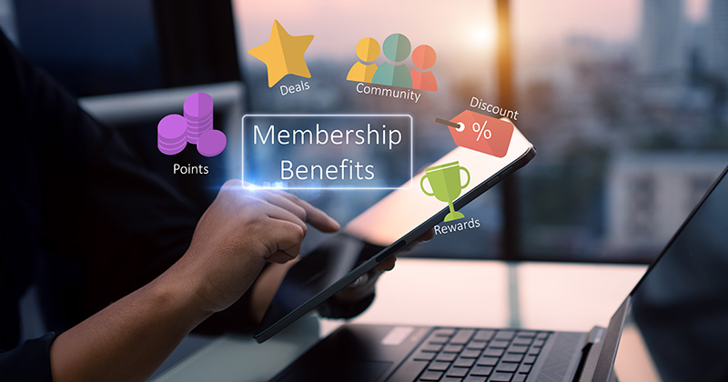 Woman-holding-a-tablet-with-a-overlay-graphic-that-reads-_membership-benefits_-and-includes-several-benefit-icons-around-it.