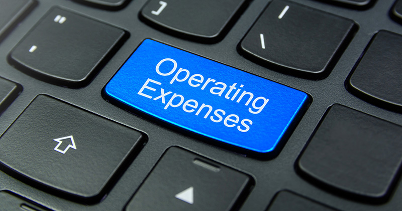 A-black-keyboard-with-one-blue-button-that-has-a-label-reading-_Operating-Expenses.